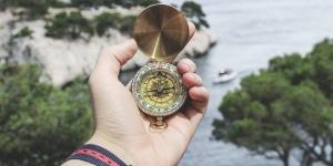 person holding compass